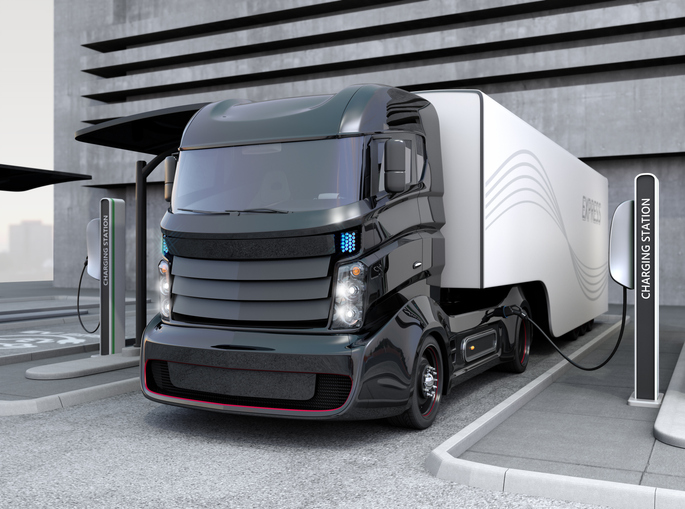 Hybrid electric truck being charging at charging station stock photo.jpg